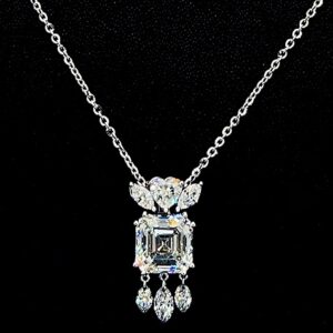 Elegant silver necklace with a sparkling diamond pendant.