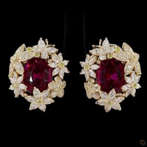 Floral earrings with red gemstones and diamonds.